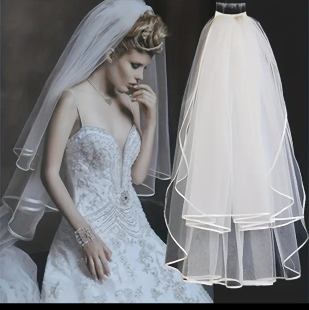 Two tiered wedding veil. With a satin outline edge. Elbow length. Named edgie.